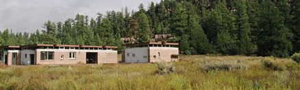 house in larger context of meadow and valley